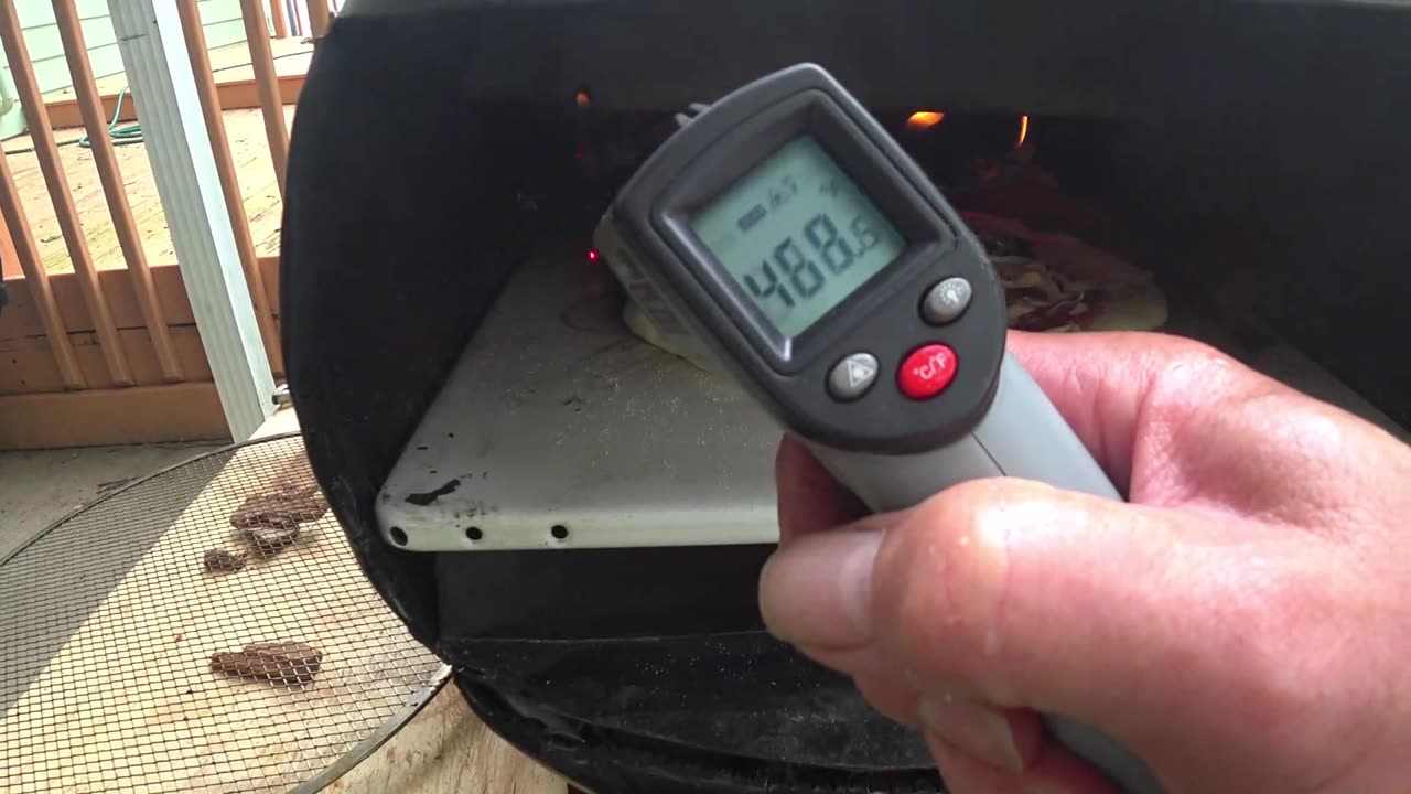 PREPARING HOME MADE PIZZA IN A HOME MADE PIZZA OVEN