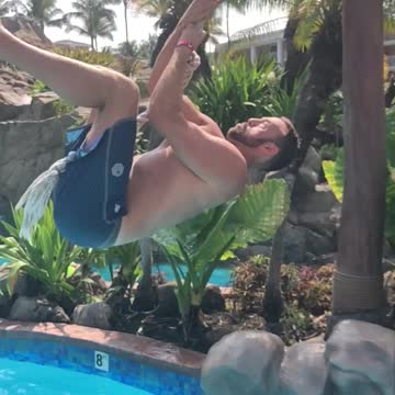 Guy slow motion rope swing fail into pool lands on back