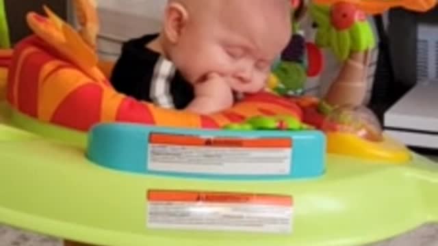 Tired baby literally falls asleep while bouncing in jumper