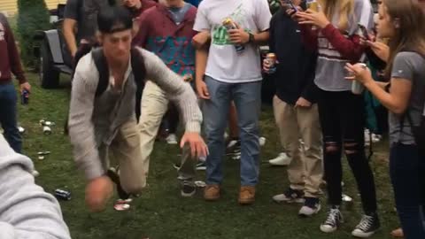 Guy in gray shirt gets tripped and tackles guy