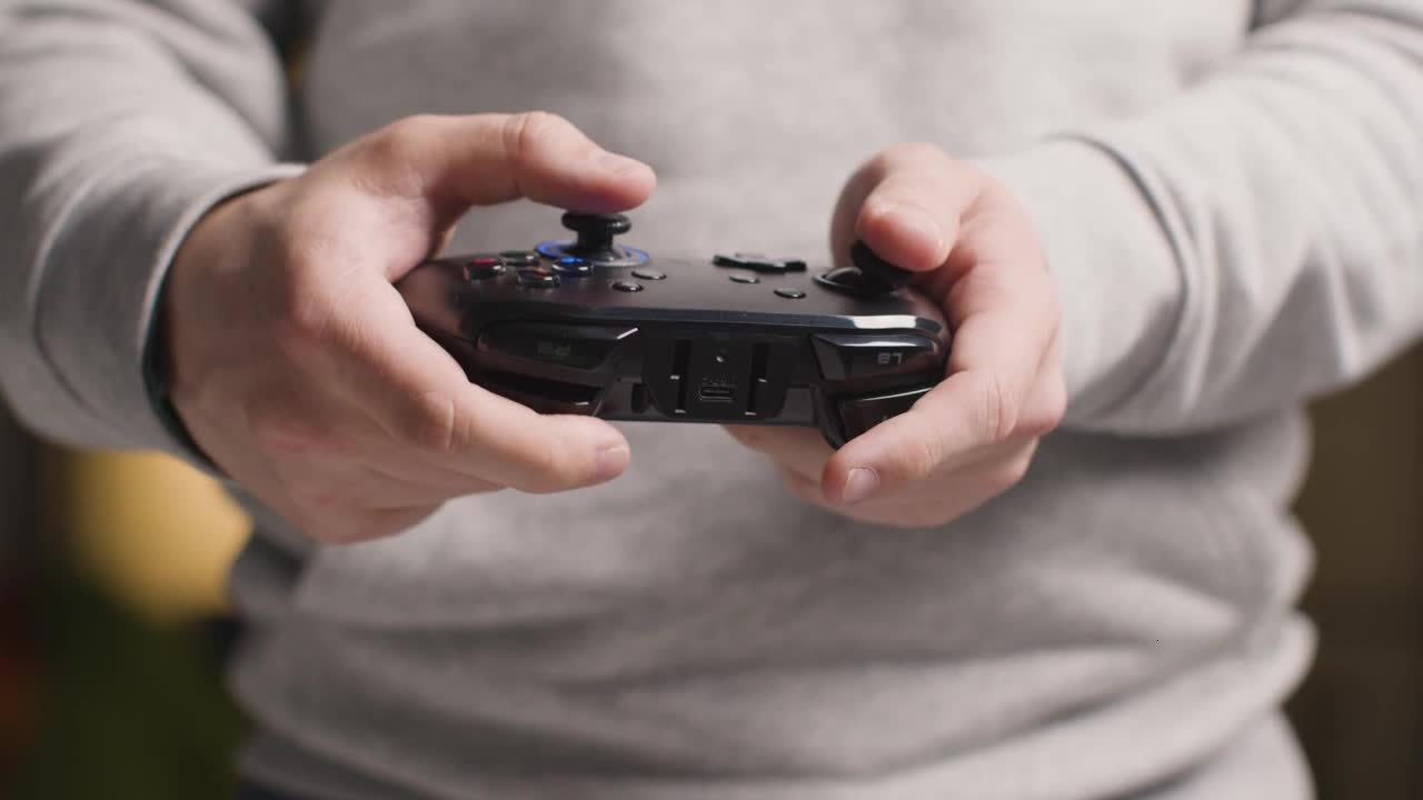 Front On Close Up Hands As Man Plays With Video Game Controller At Home 11