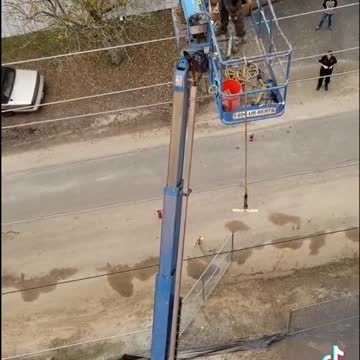 A crane is burning, with a man in it