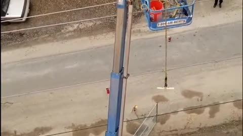 A crane is burning, with a man in it