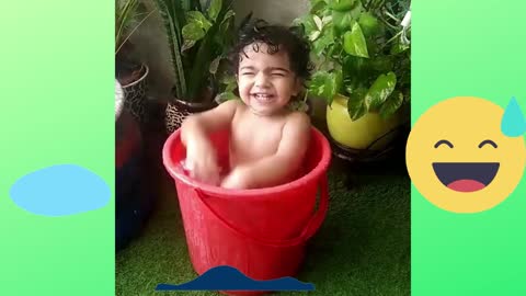 Kid playing in water bucket