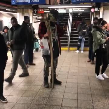 Man green skull face makeup wood stick