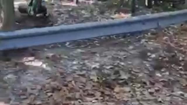 Guy in green flips over on bike over metal railing