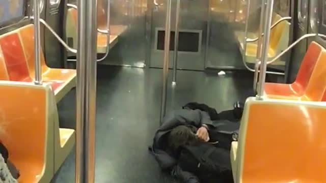 Man in all black passed out on floor
