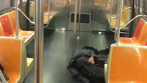Man in all black passed out on floor