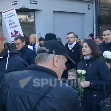 Latvian SS legionnaires hold a traditional procession in Riga