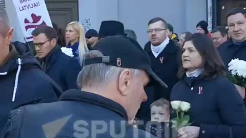 Latvian SS legionnaires hold a traditional procession in Riga