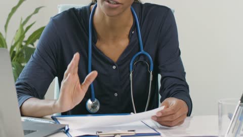 Mid Section Female Doctor Discussing Results With Patient