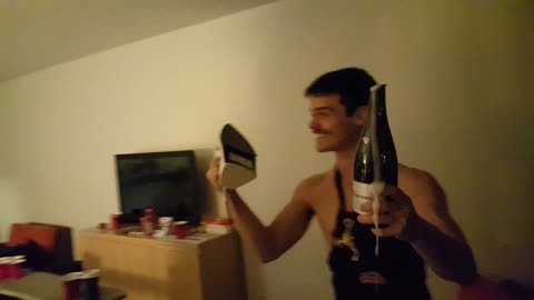 Mustache guy opens champagne bottle with iron