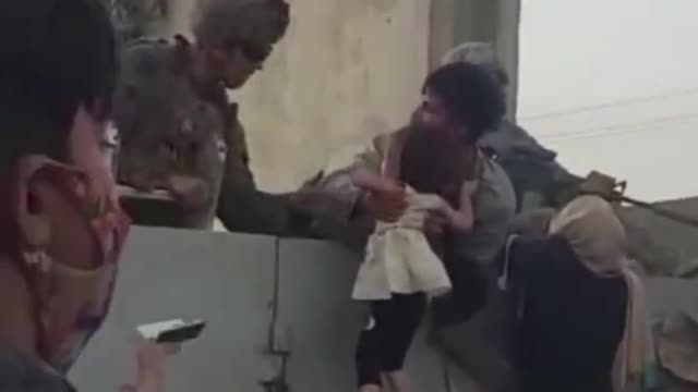 Babies and children are being pulled over the wall by U.S.