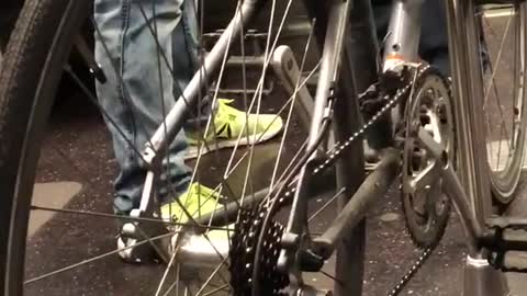 Silver bike locked to subway train pole