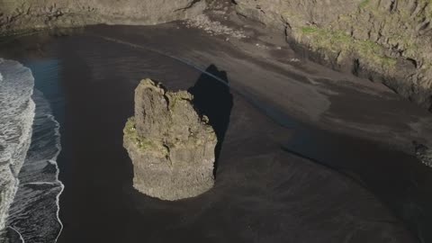 Black sand beach rock formation
