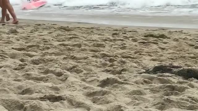 Two kids knocked down by wave on boogie boards