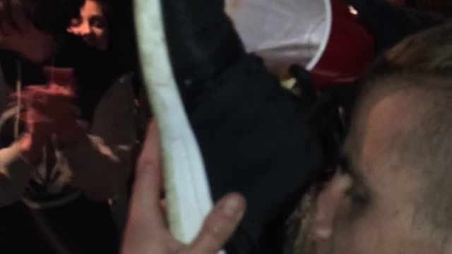 kid drink from shoes at party