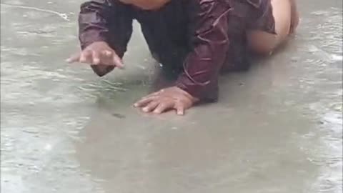 CUTE LITTLE BABY PLAYING DURING RAIN