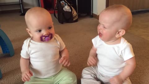 Twin baby girls fight over pacifier