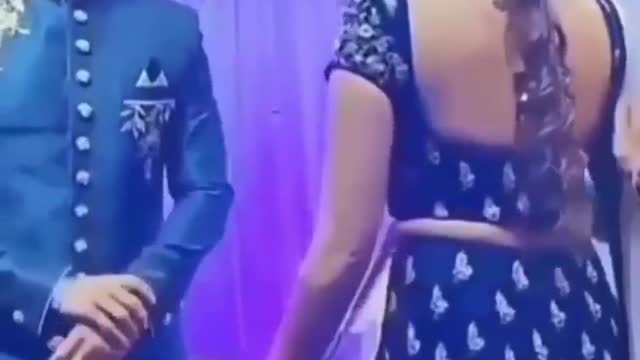 When the bride sat on the stage publicly doing this, the groom's tongue came out, then did this