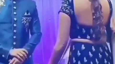When the bride sat on the stage publicly doing this, the groom's tongue came out, then did this