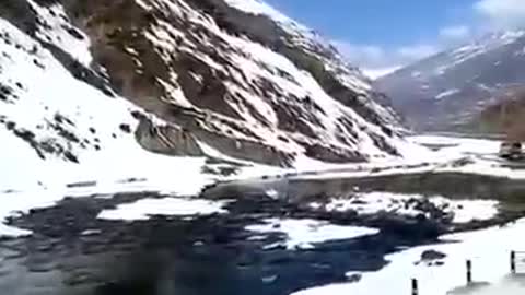 Person Witnesses Beautiful Snow-covered Mountains And Water Stream In Himachal Pradesh