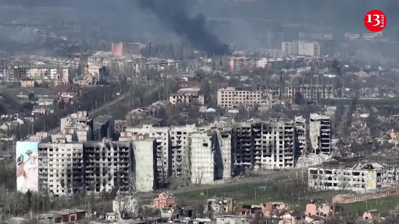 Drone shows smoke rising among destroyed buildings in Bakhmut