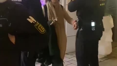 German police detain an elderly woman