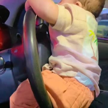 Cute baby driving car