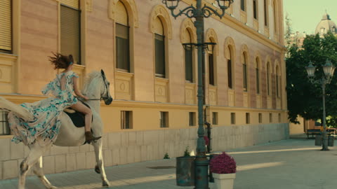 Woman Riding A Horse In The Street