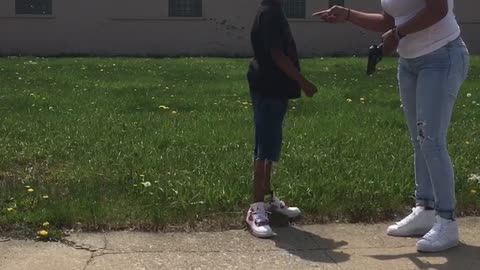 Woman Takes Away Fake Gun From Boys Walking Down Street