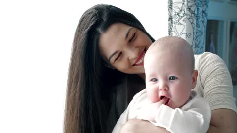 Happy mother hugging her baby