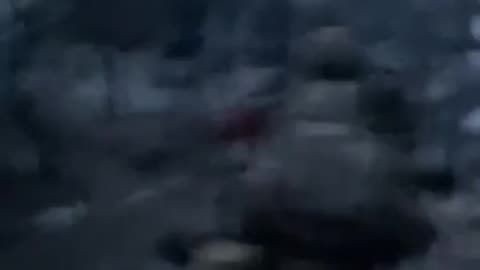 Russian soldiers running into an apartment building in central Vovchansk