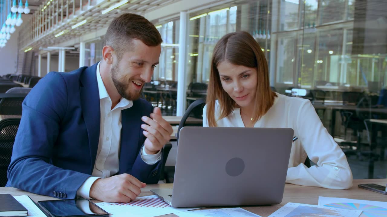 Two coworkers talking and laughing