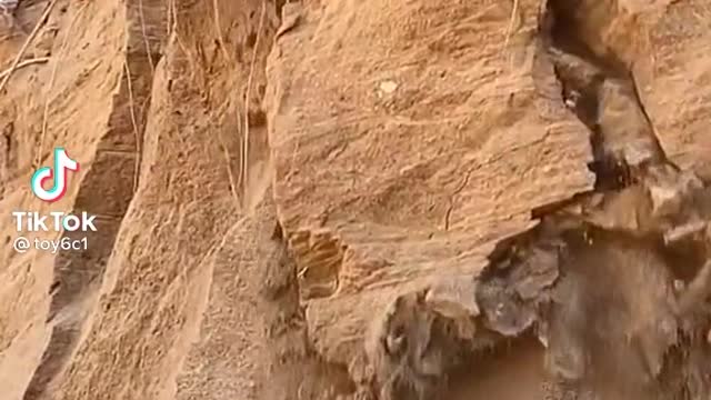 Hill broken and JCB machine dropping from hill