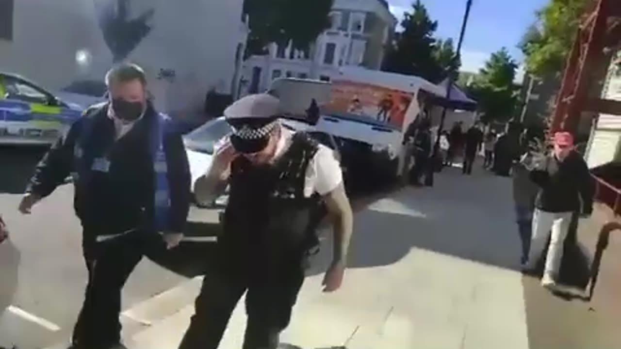 Man collapses on the sidewalk after leaving the vaccine death bus.