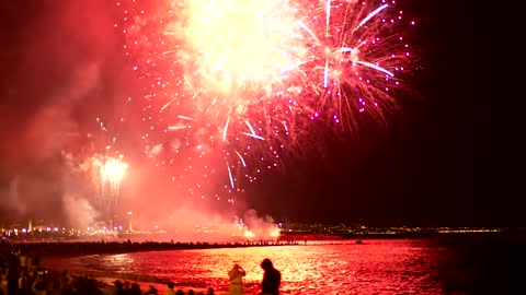 Fireworks illuminating the beach sky