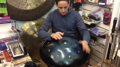 Guy rocks out on a hung drum