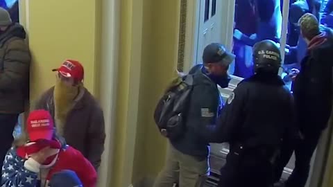 Capitol officer having a friendly conversation and dapping up "insurrectionists"