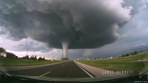 Storm chasing dashcam: Tornado crossing the highway! Laramie, Wyoming
