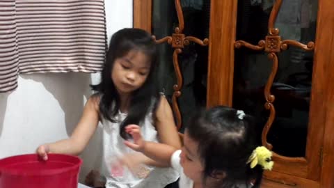 Playing withbher big sister.