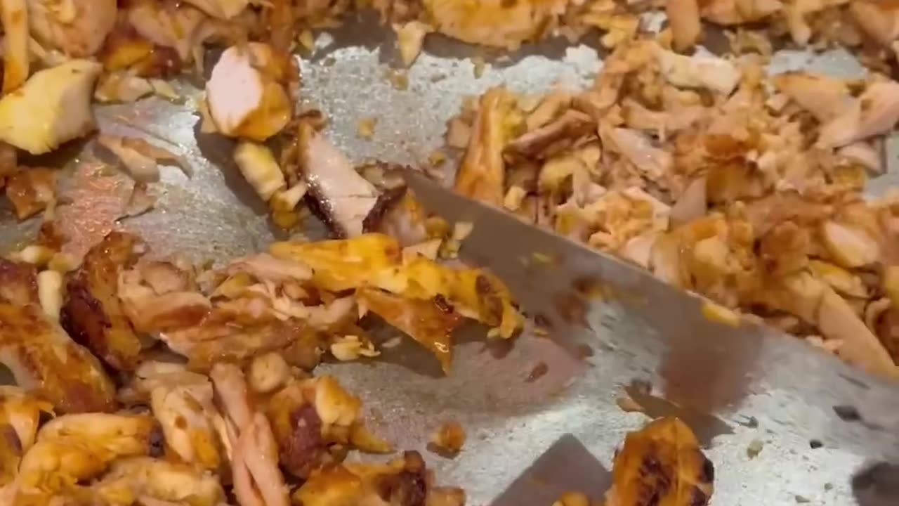 The shaurmist cuts the bread, the crust crunches so appetizingly