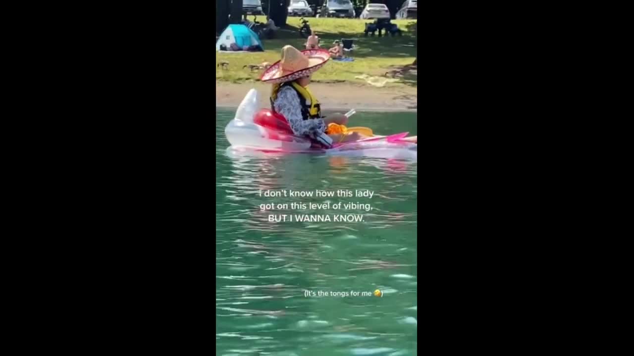 Lady is living her best life paddling & eating at the lake