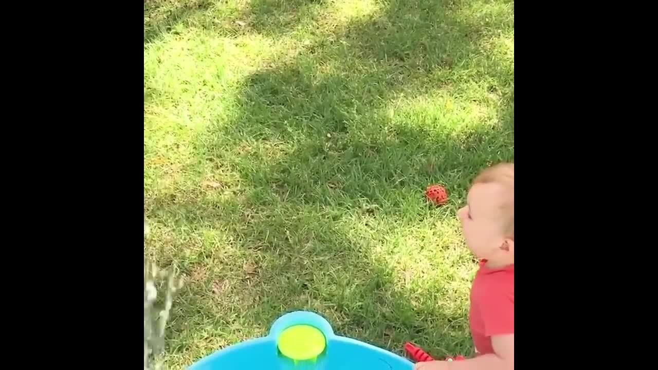 A happy moment for the baby to play with water