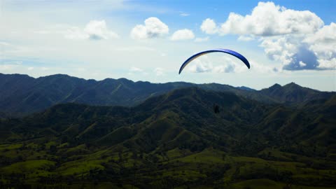 Skydiver flying over a mountain range