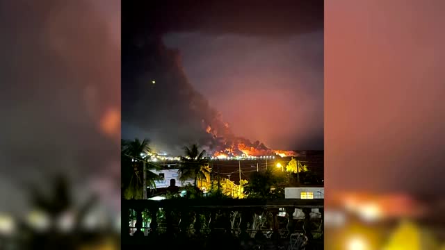 Fire rises above fuel tanks after explosion in Cuba