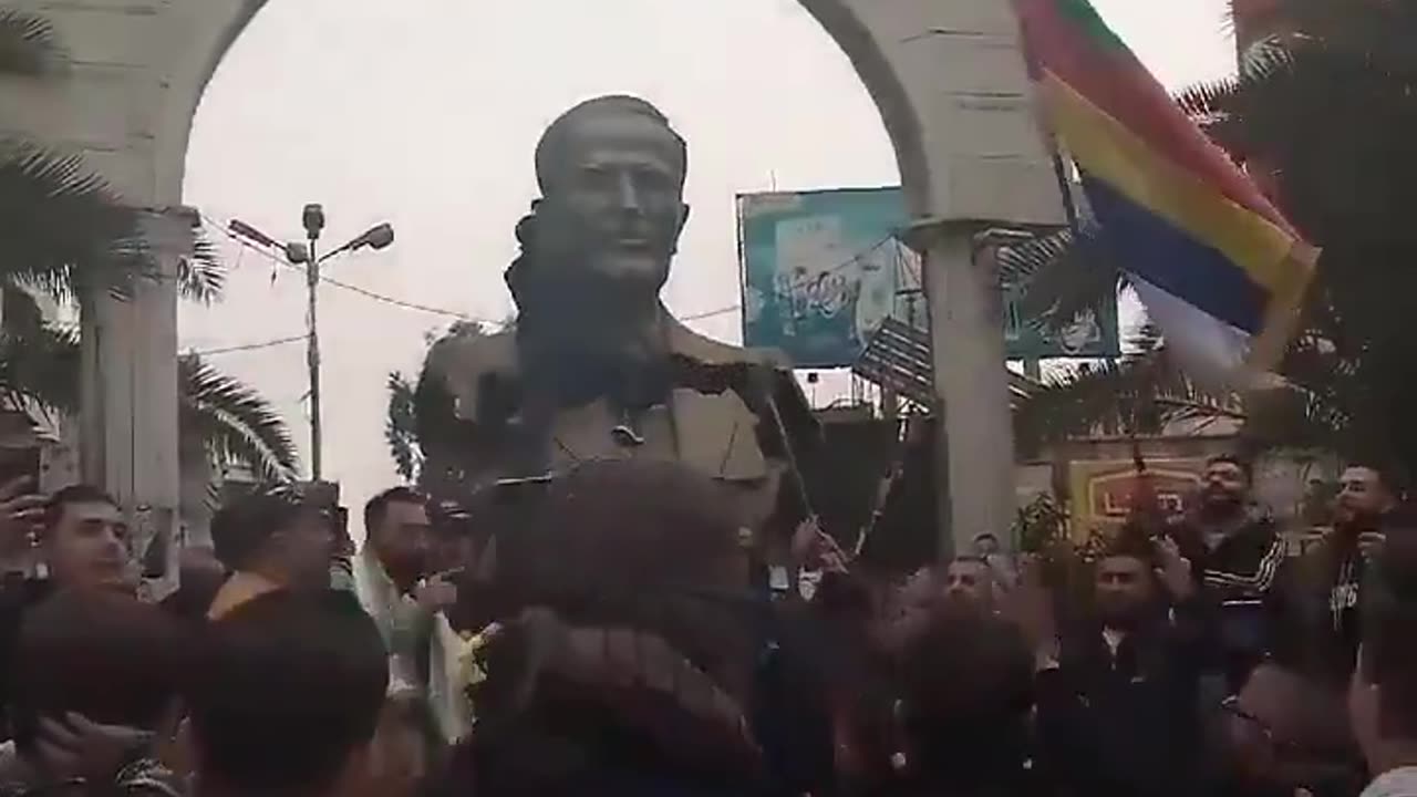 Syrians Topple Hafez al-Assad Statue In Damascus Suburb