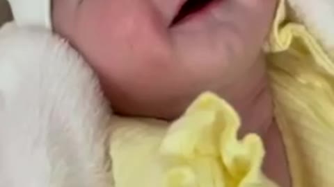 Newborn baby preciously smiles when kissed