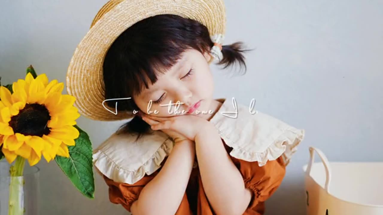 Super cute baby holding sunflower