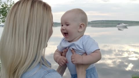 mother plays with her baby